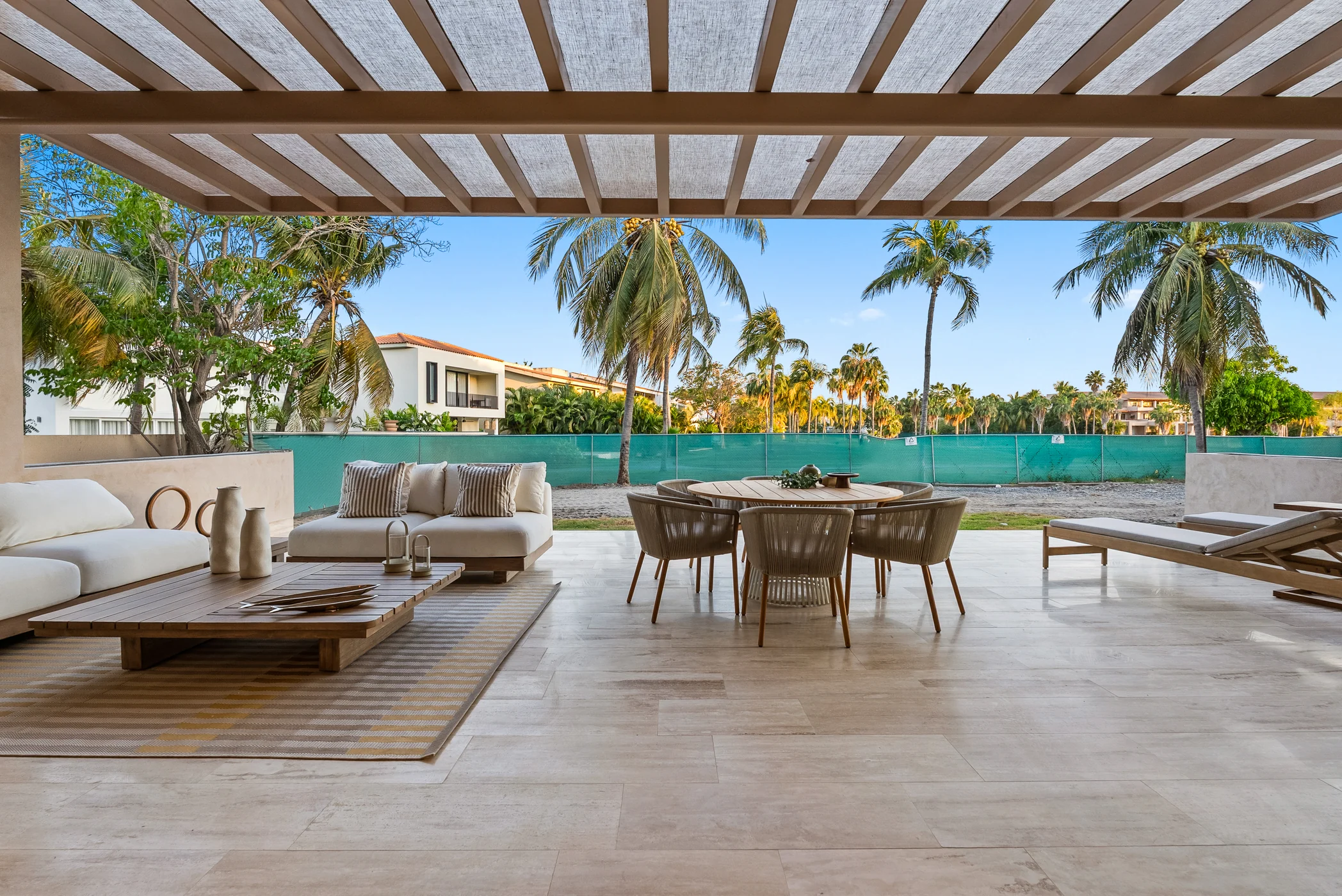 Residential terrace overlooking the pool and tropical greenery