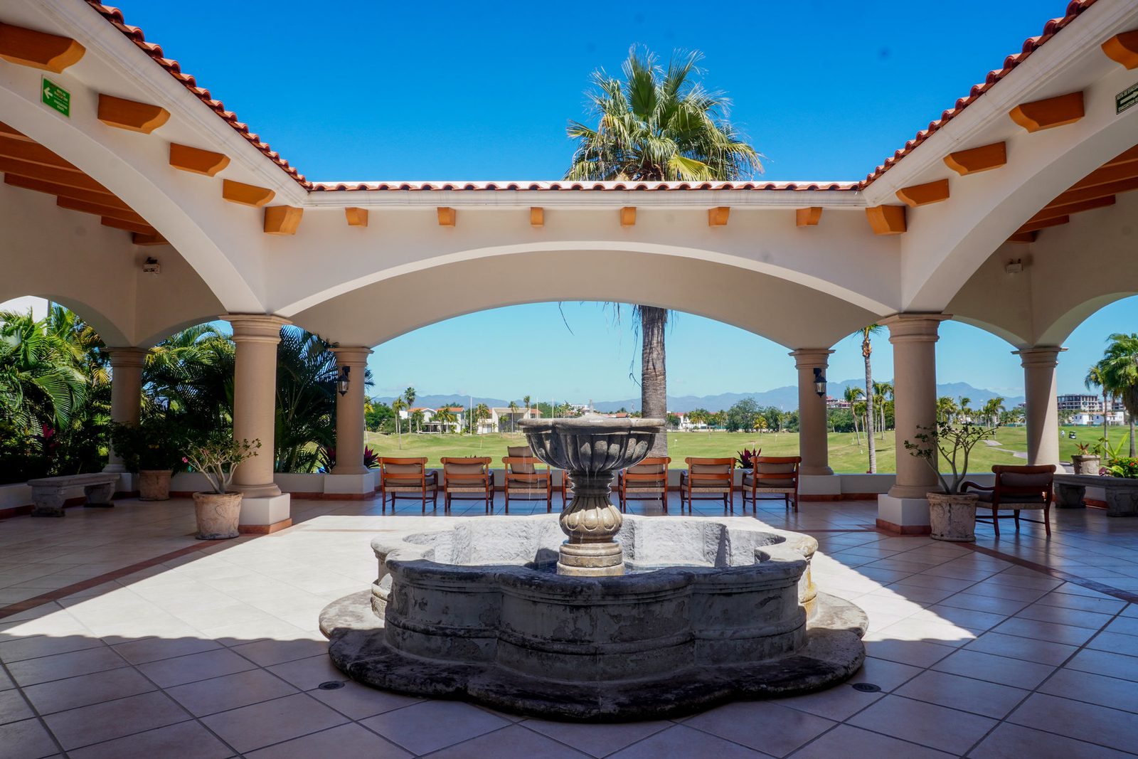 Residential courtyard with arches and an outdoor fountain